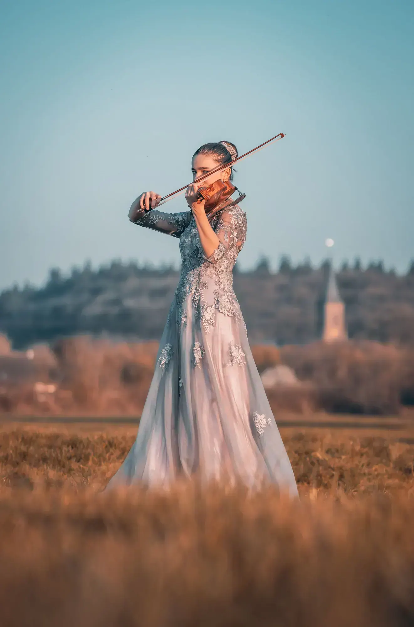 Kim Marie Borger spielt Viola im Abendlicht eines weiten Feldes